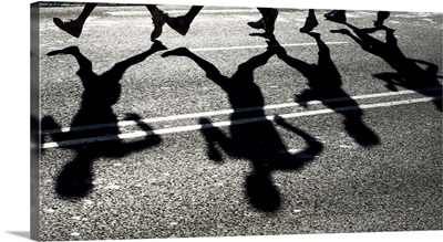 Shadows Of Several Athletes Dance On Road In Bright Sunlight During 20Km Walk Event