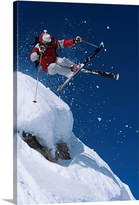 Skier In Mid-Air Above Snow On Ski Slopes