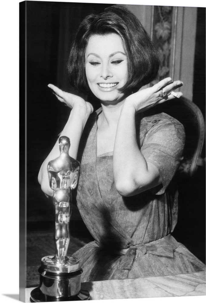 Sophia Loren as she receives the Oscar statuette from producer Joseph Levine in Rome, April 4, 1962. She won the Academy A...