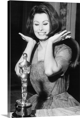 Sophia Loren as she receives the Oscar statuette from producer Joseph Levine