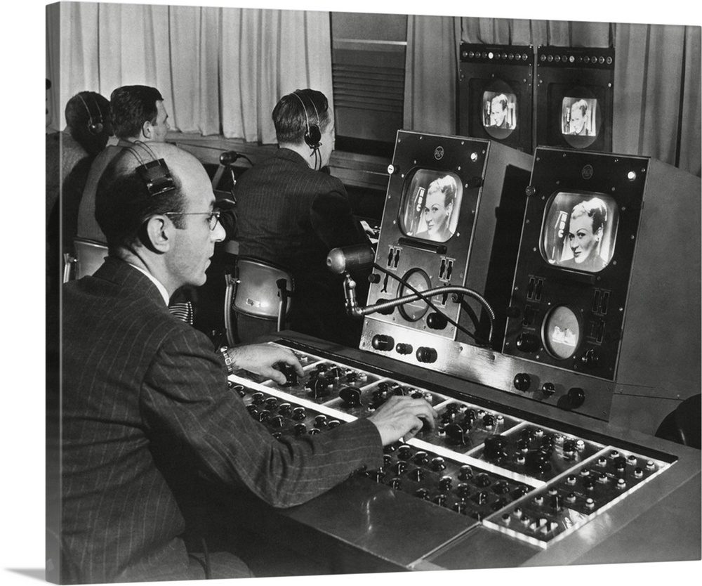 Television studio engineer gets several views of the image and use the complicated set of dials to control the tone and qu...