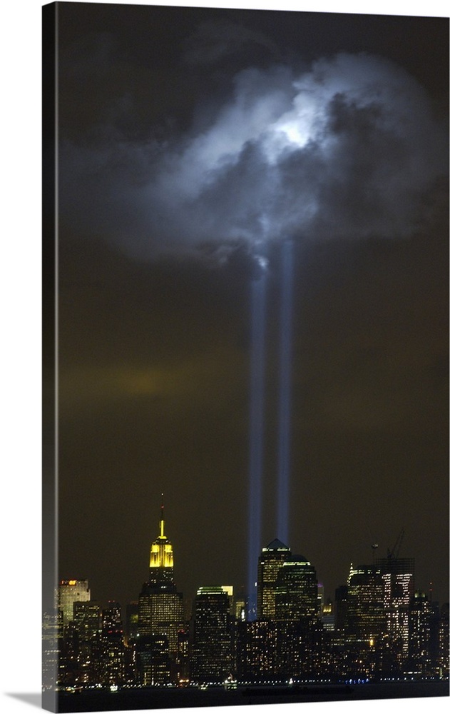Tribute in Light Memorial illuminates a passing cloud above lower Manhattan. Sept. 9, 2004. The twin towers of light, made...