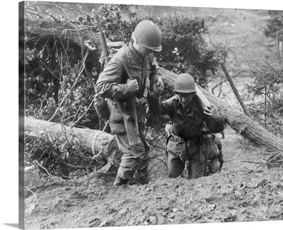 U.S. Infantrymen, In Hurtgen Forest. Soldier Helps Another Carrying Weapon, WWII