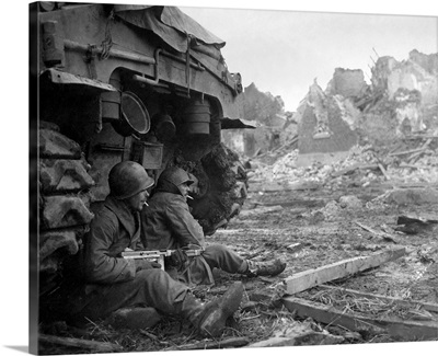 U.S. Infantrymen Sheltering Behind Tank During Heavy German Shelling. Dec. 11, 1944