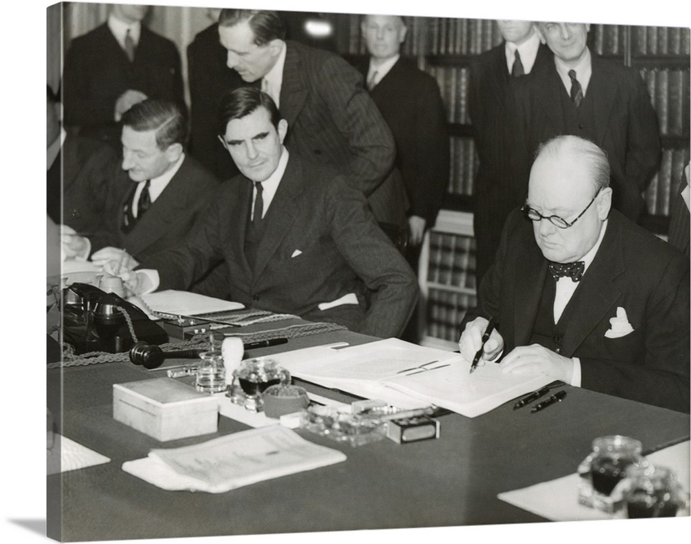 Winston Churchill signing the 'Lend Lease' agreement to lease British bases to the U.S. March 11, 1941. From his desk at 1...