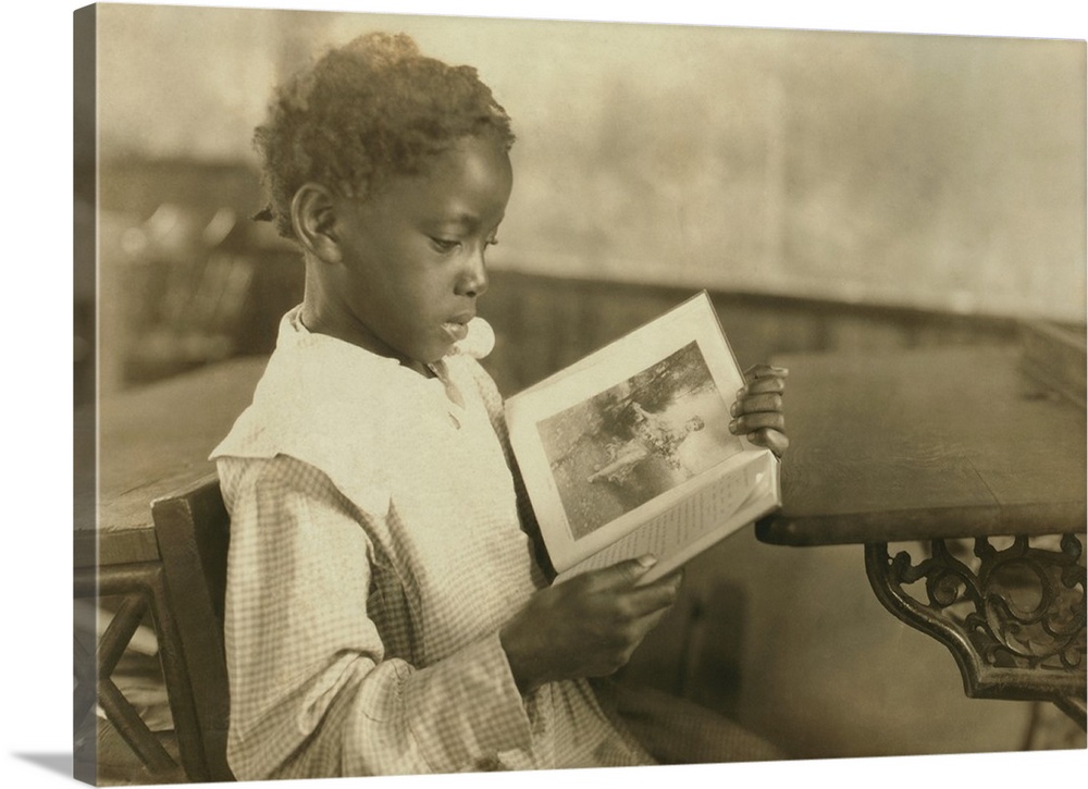 Young girl reading an illustrated book in Pleasant Green School, near Marlinton, West Virginia. The one-room school was on...
