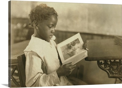 Young girl reading an illustrated book