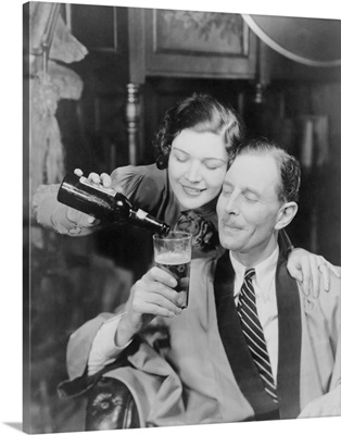 Young woman pouring beer into a man's glass, 1933