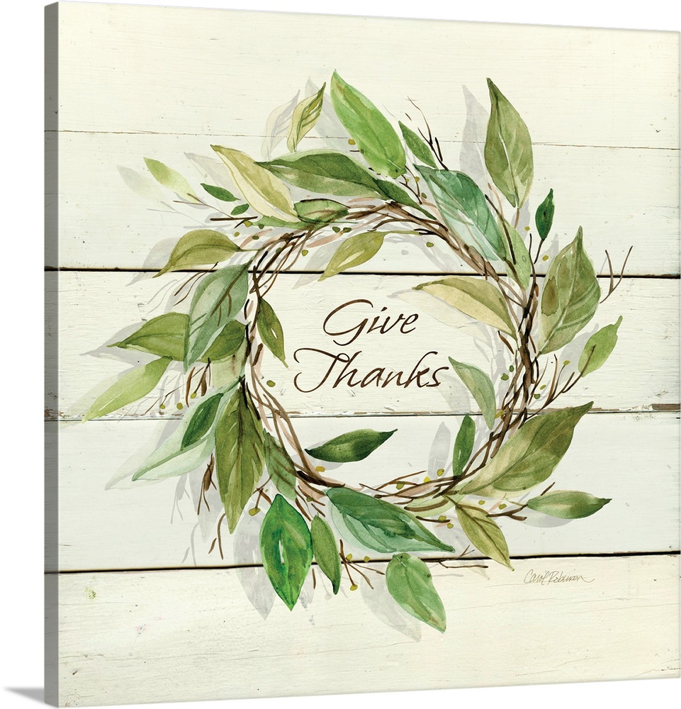 Decroative artwork of a wreath of leaves with the text "Give Thanks" in the middle on a white wood backdrop.