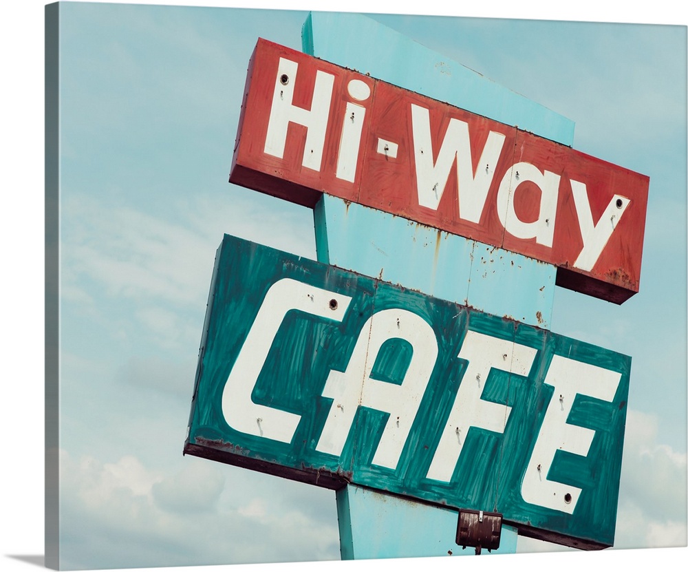 Photograph of a retro blue and red 'Hi-Way Cafe' sign with a blue sky background.