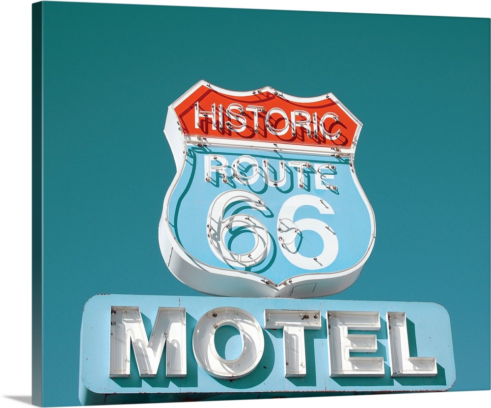 Photograph of an antique Route 66 Motel sign on a clear blue sky background.
