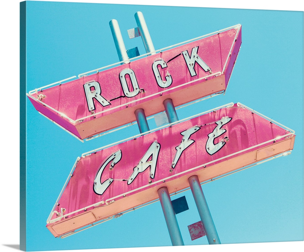 Photograph of a retro pink and white 'Rock Cafe' light up sign on a blue sky background.