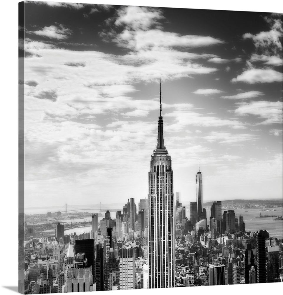 Black and white square photograph of New York City from a bird's eye view, highlighting the Empire State Building.