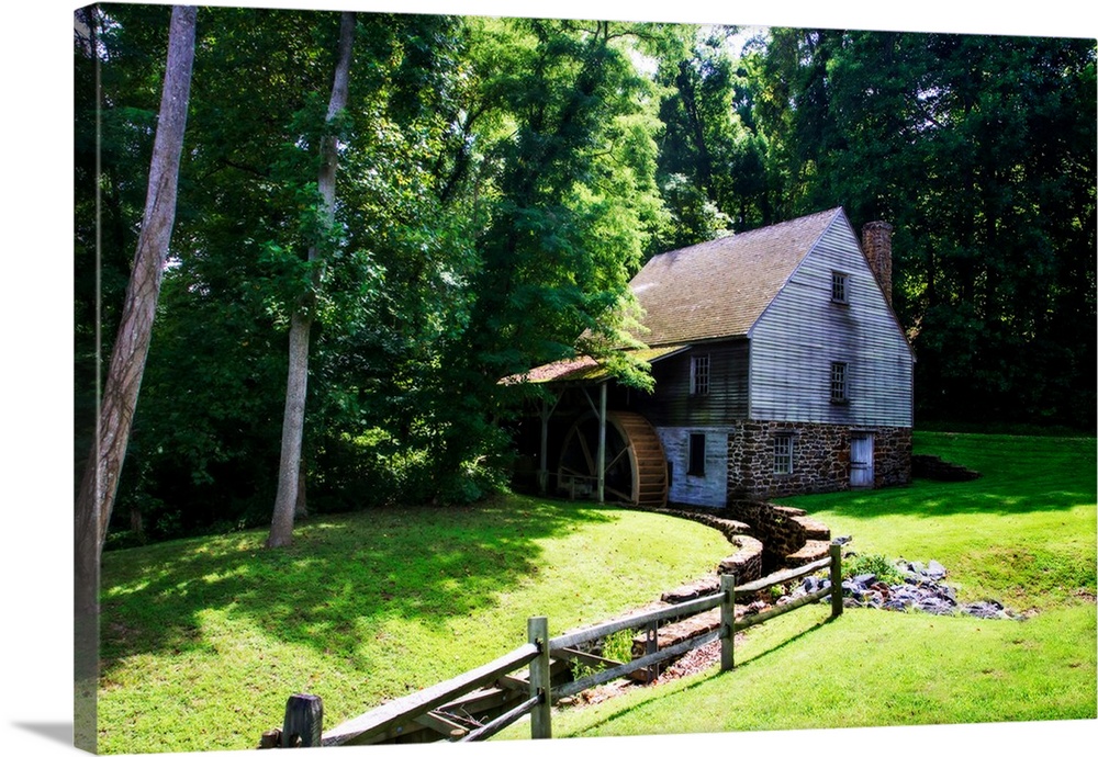 Photograph of an 18th Century Grist Mill surrounded by greenery.