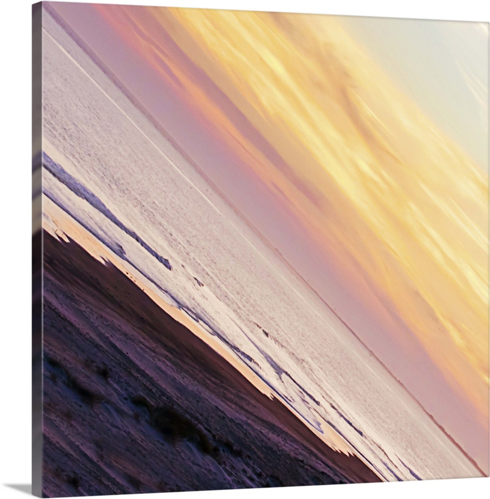 A pastel-colored sky at sundown seen at a sharp angle, creating an abstract image.