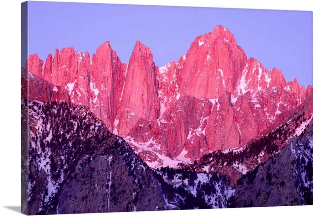 Pink and purple toned photograph of rocky mountain peaks on Mt. Whitney at sunrise.