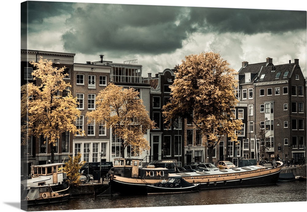 Boats docked along the canal in Amsterdam in the fall.