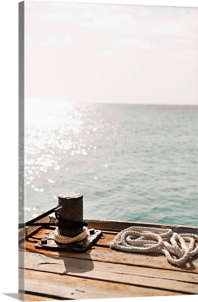 Photograph of a floating dock waiting for a boat to tie up with the Caribbean in the background.