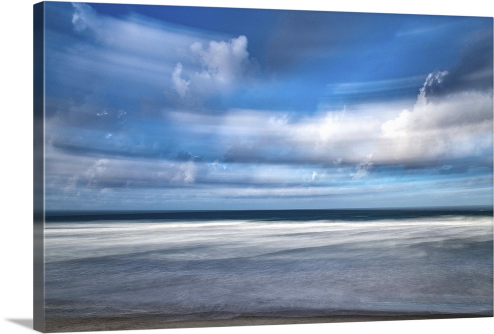 Photograph of storm clouds at beach blurred with long exposure.