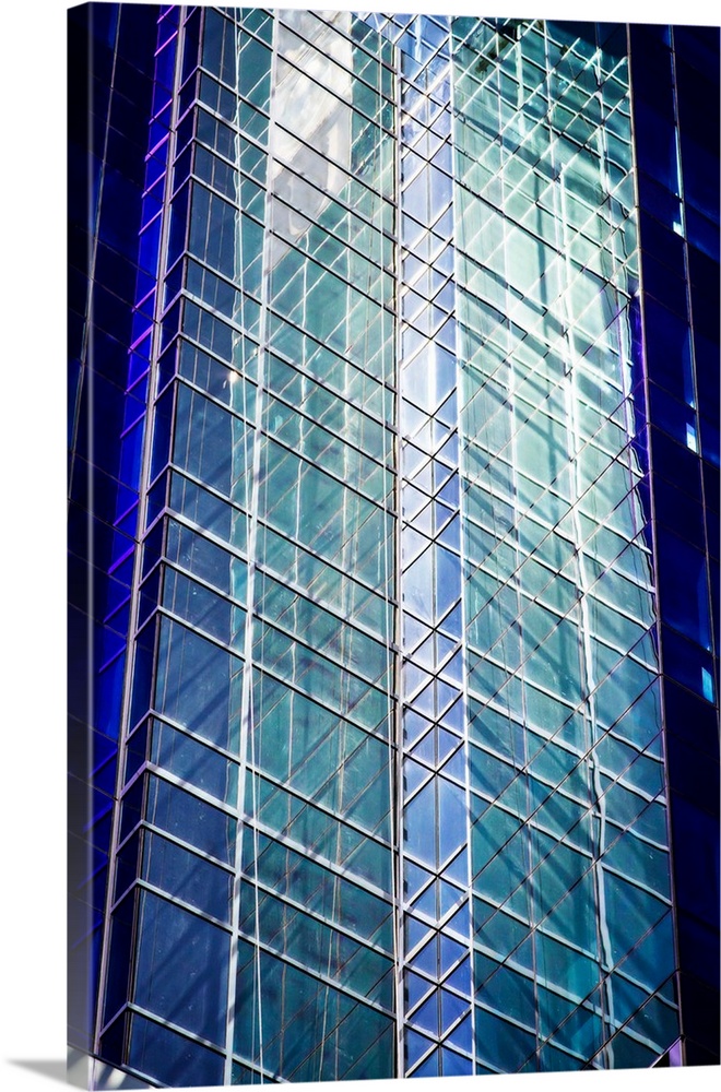 Architectural abstract photograph of the side of a glass building.