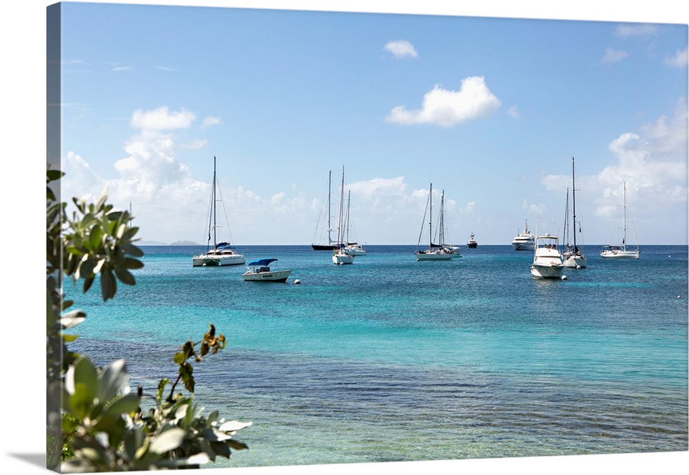 Photograph of sailboats on the crystal blue waters of the Caribbean.