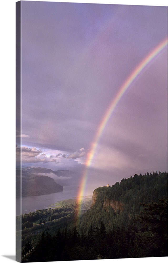 A rainbow across a pastel lavender sky over the Columbia River Gorge.