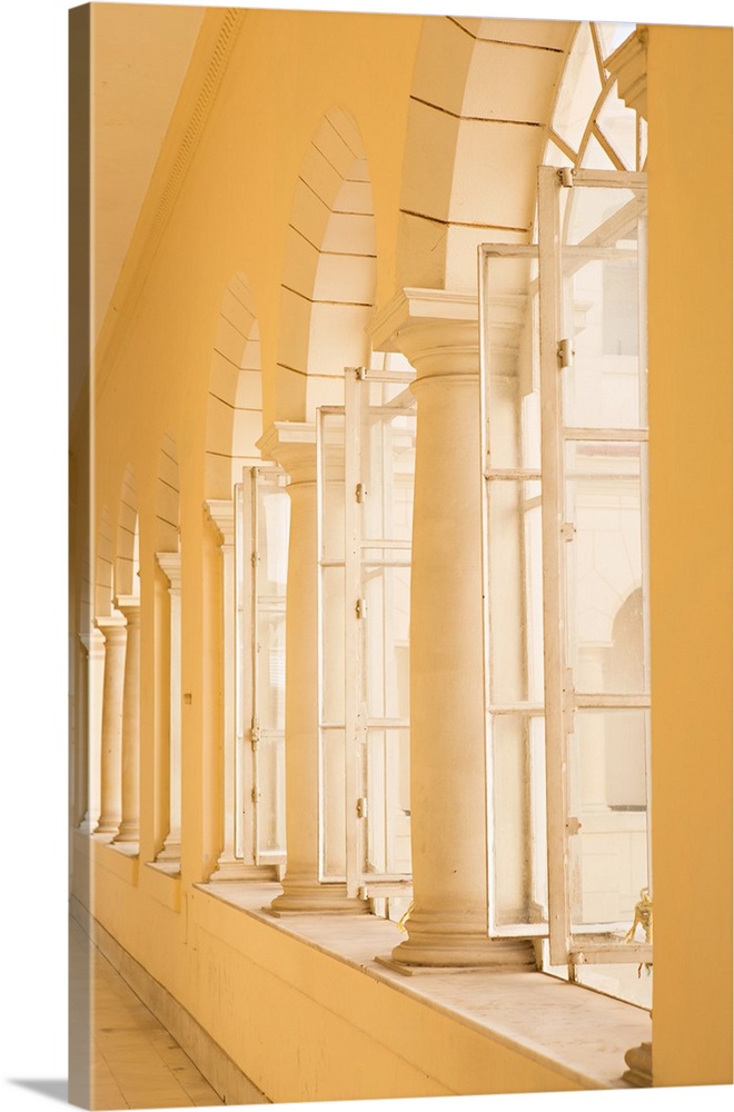 Architectural photograph of columns lining arched windows at The Museum of the Revolution in Cuba.