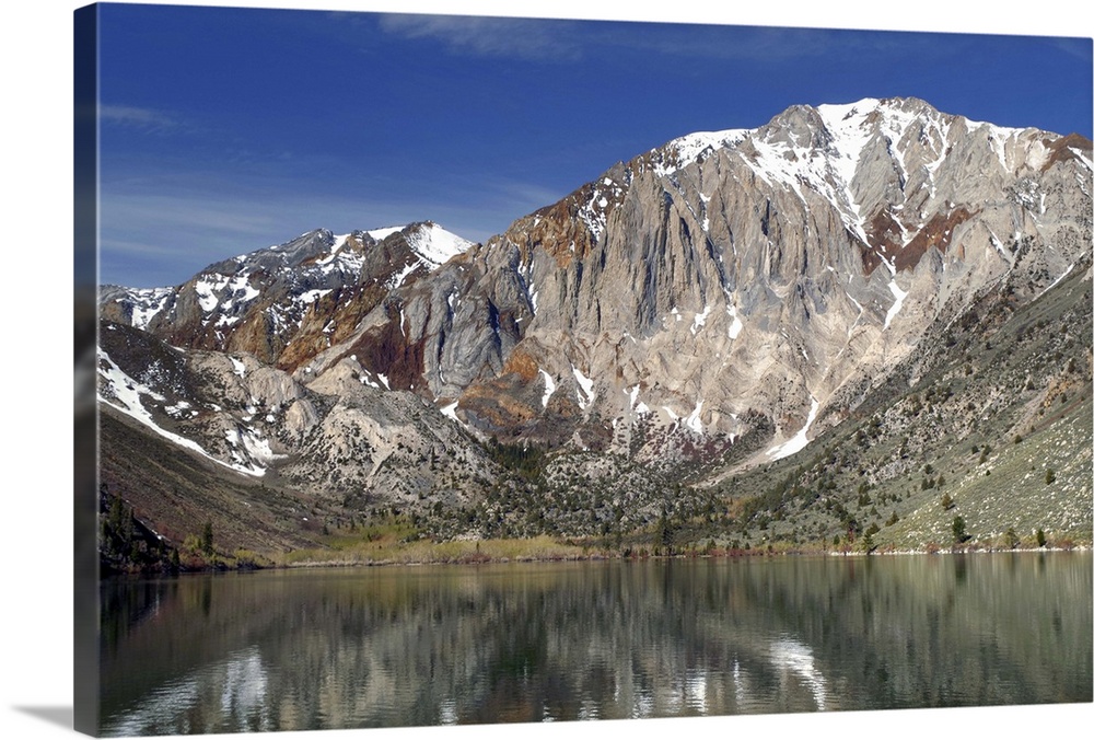 Landscape photograph of Convict Lake with a rocky mountain range in the background.