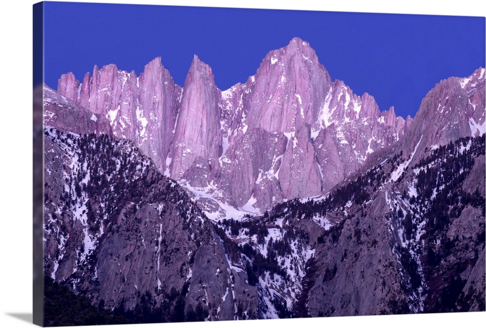 Purple and blue toned photograph of rocky mountain peaks on Mt. Whitney at sunrise.