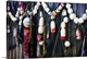 image thumbnail of An assortment of multicolored buoys hanging on a wooden wall.