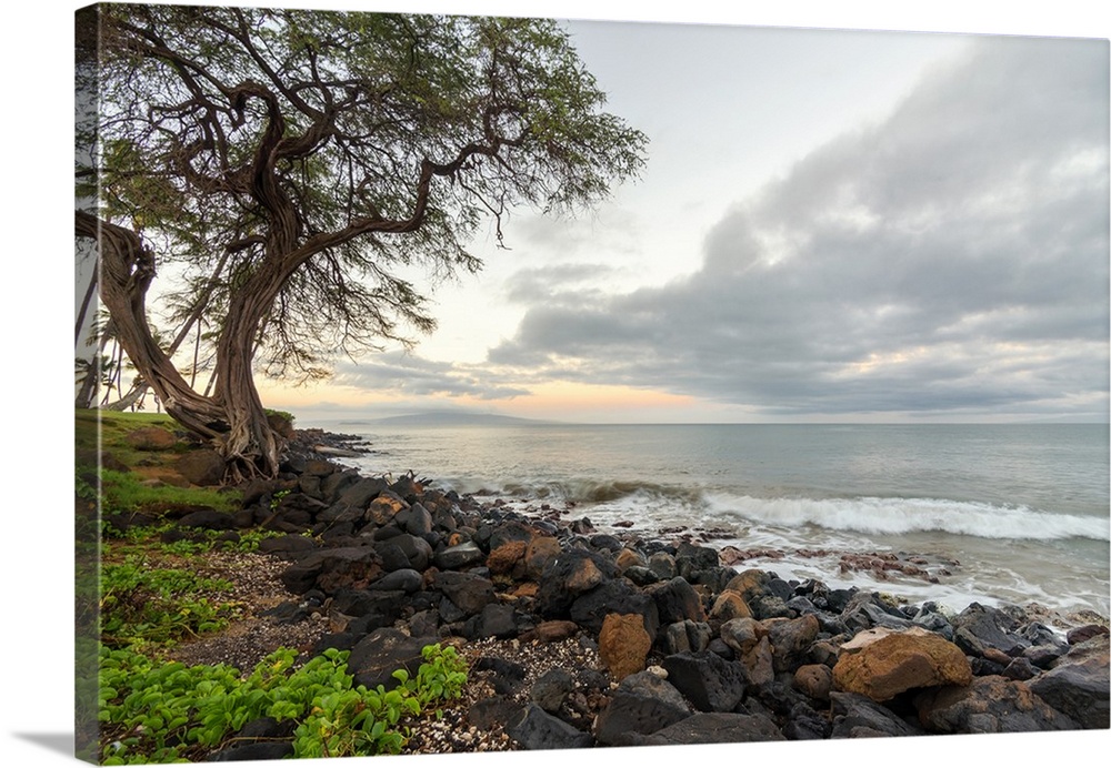 Landscape photograph of a sunrise over the rocky shoreline in Kihei, Hawaii.
