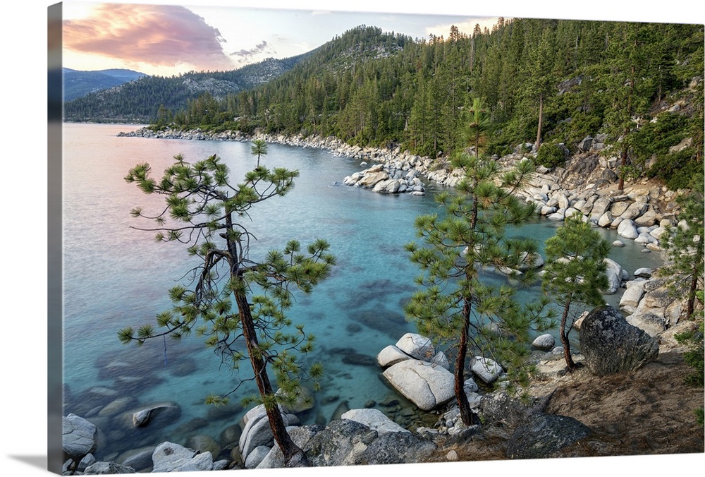 Landscape photograph of Lake Tahoe with clear blue water at sunset.