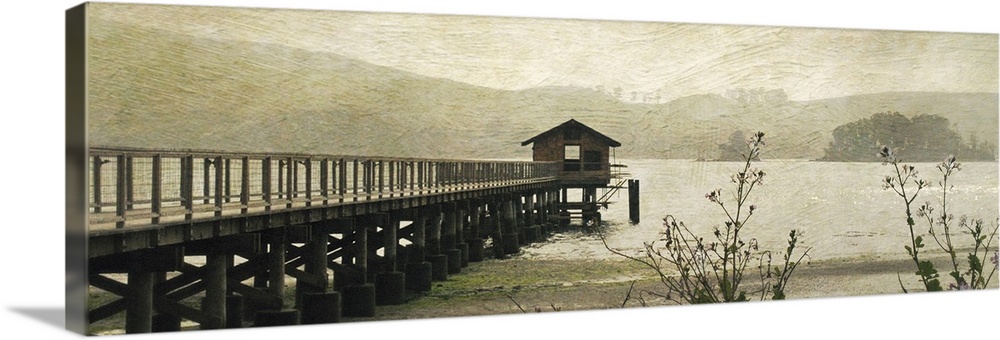 Wide angle, fine art photograph of a pier extending into the water, a small hut at the end.  An overcast day, with swirlin...