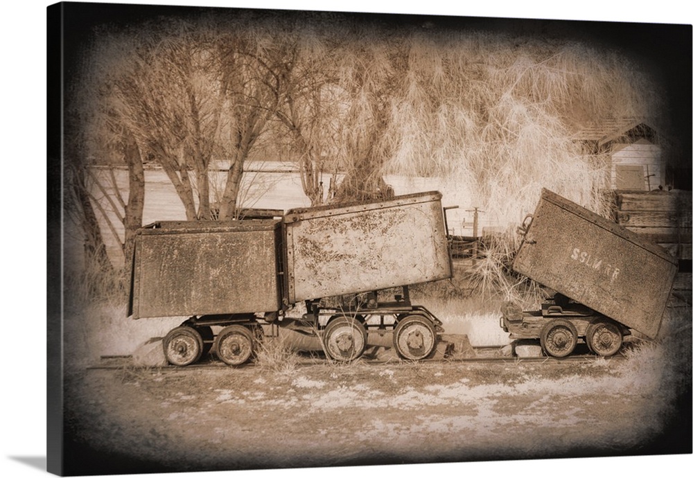 Antique photograph of mine carts with a dark vignette.
