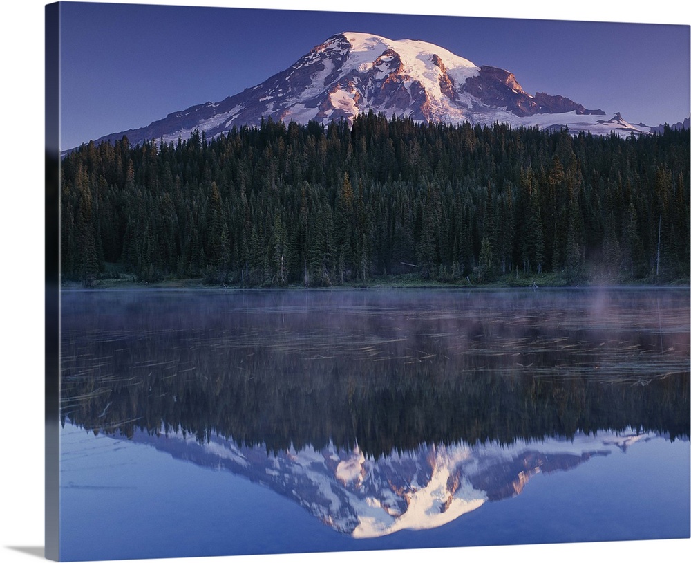 Mount Rainier and the surrounding forests reflected in a lake, Washington.