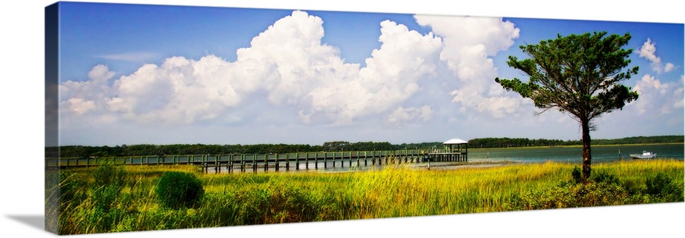 Panoramic photograph of a dock stretching out over the Newport River in North Carolina.