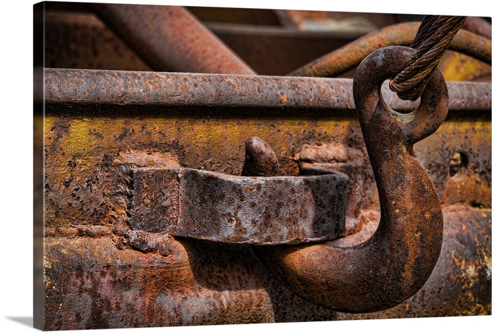 A close up photo of parts of a vintage truck that have completely rusted over time.