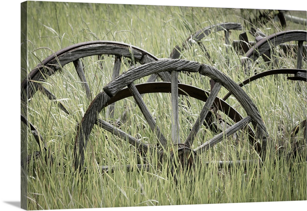 Old wagon wheels in field - Canada, British Columbia, near Cache Creek, Historic Hat Creek Ranch.
