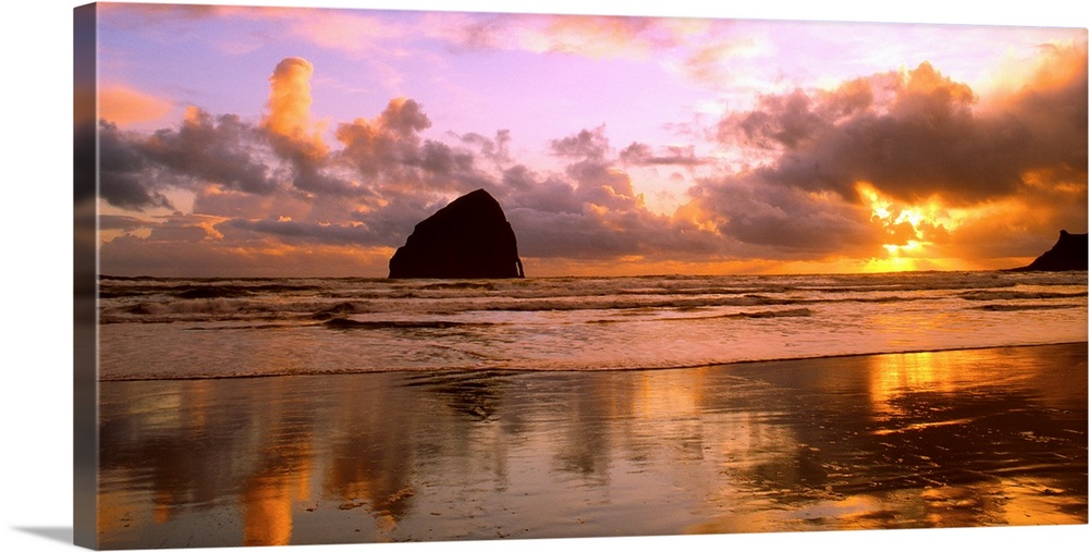 Sea stacks on the beach silhouetted at sunset, Pacific City, Oregon.