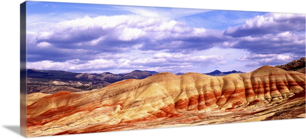 Large white clouds over the Painted Hills in Oregon.
