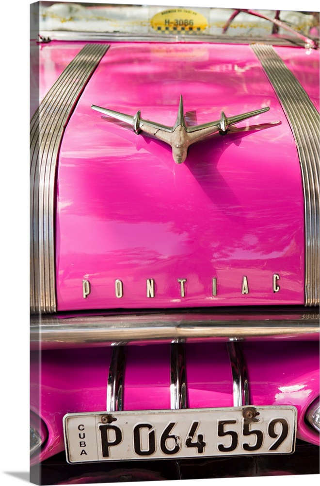Photograph of the front of a hot pink vintage Pontiac car in Cuba.