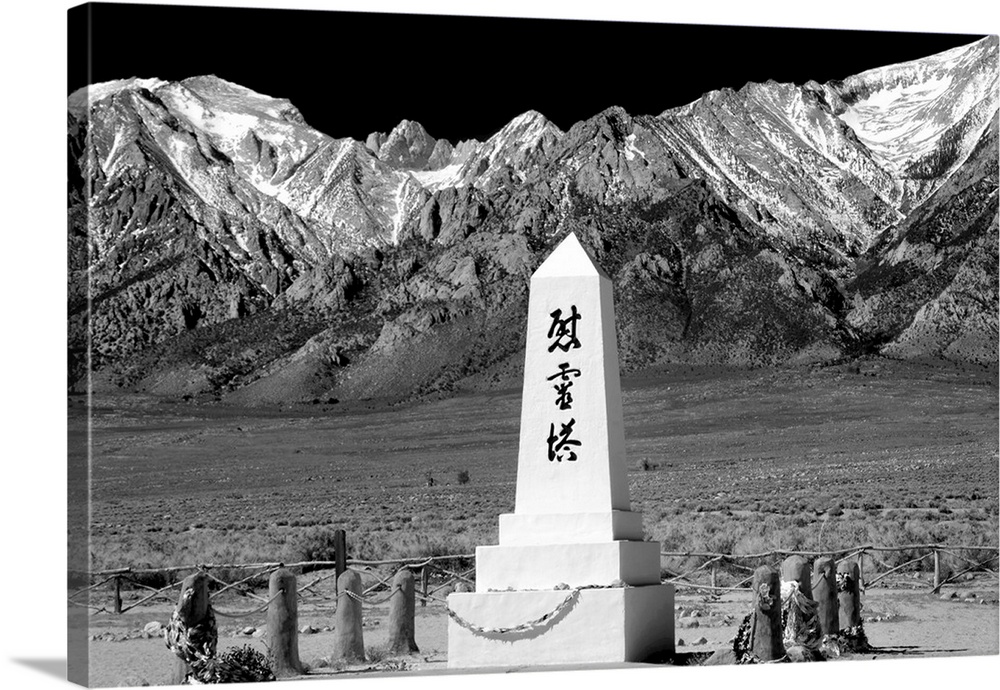 Black and white photograph with a WWII monument in front of the Sierra Nevada mountain range.