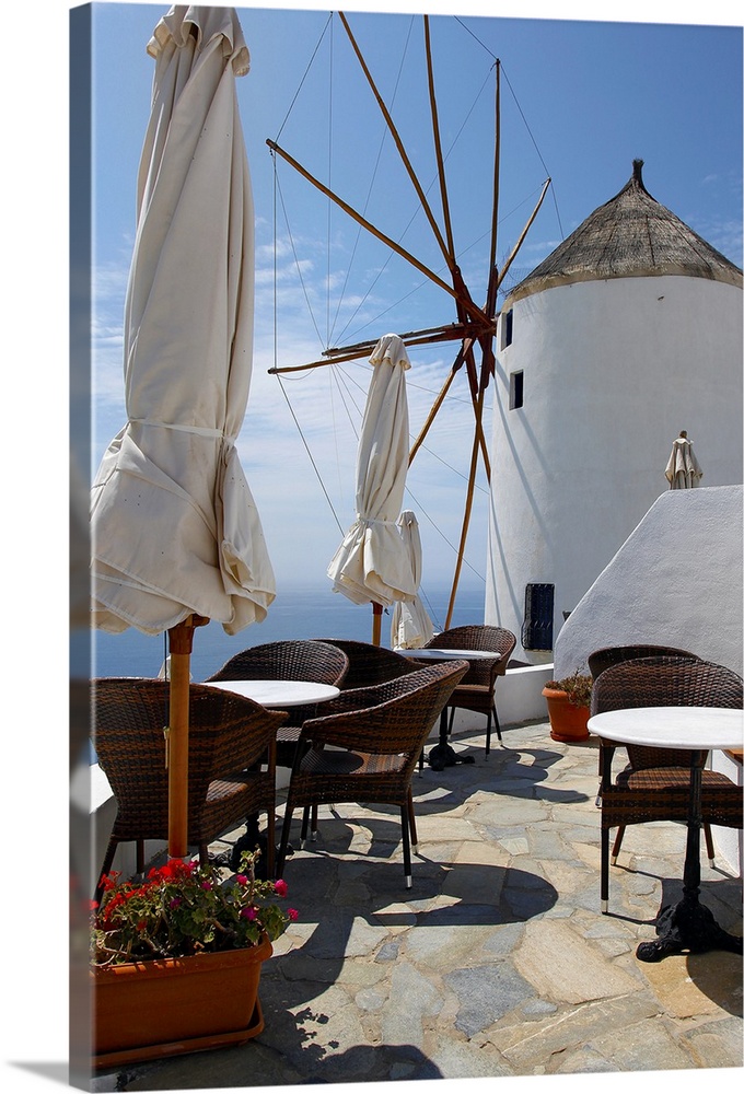 Restaurant on deck with windmill overlooking ocean in Santorini, Greece