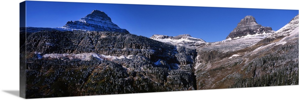 Panoramic photograph of snow covered mountains at Glacier National Park.