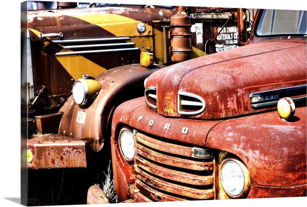 Photograph of an old and rusty antique Ford truck.