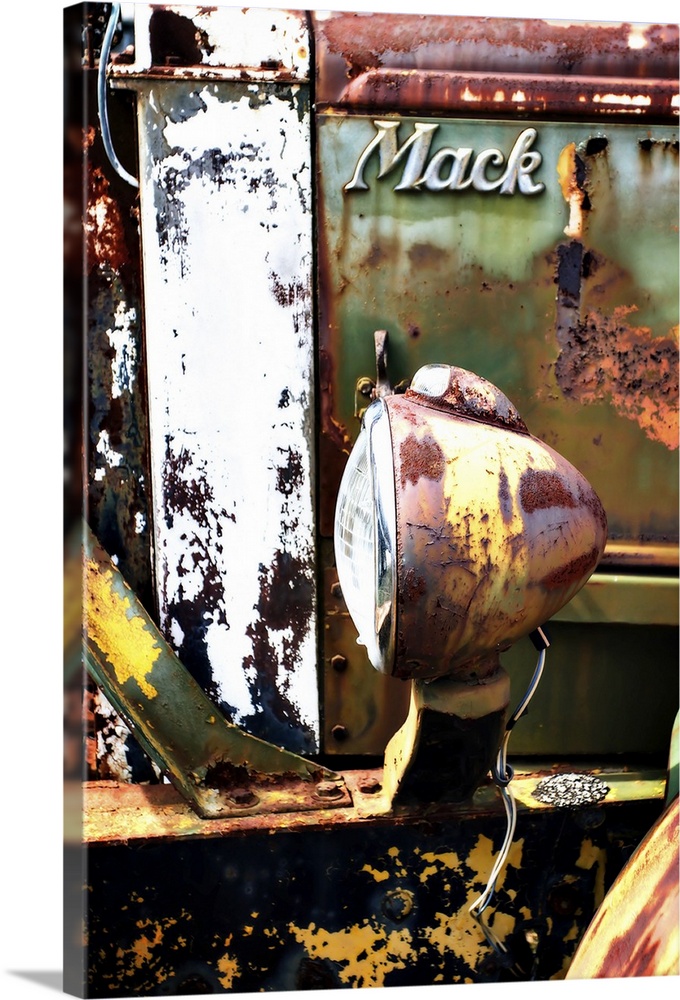 Close-up photograph of Mack truck headlight covered in rust and texture.