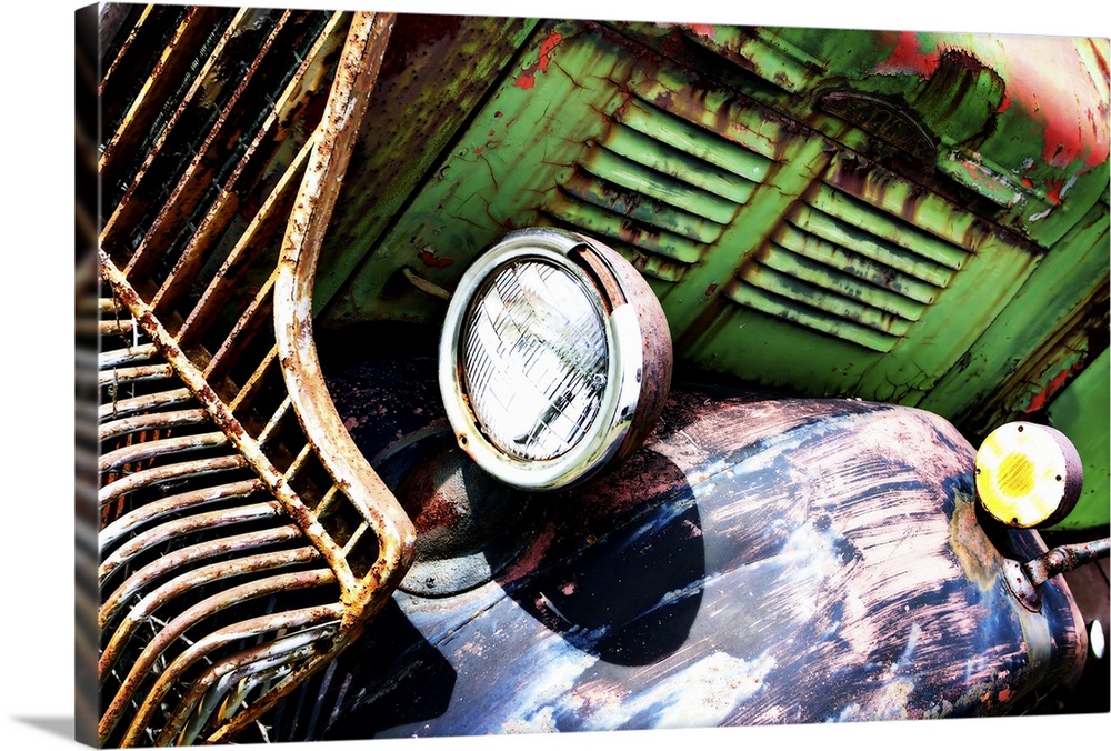 Photograph of an old, rusted, green truck from a unique angle.