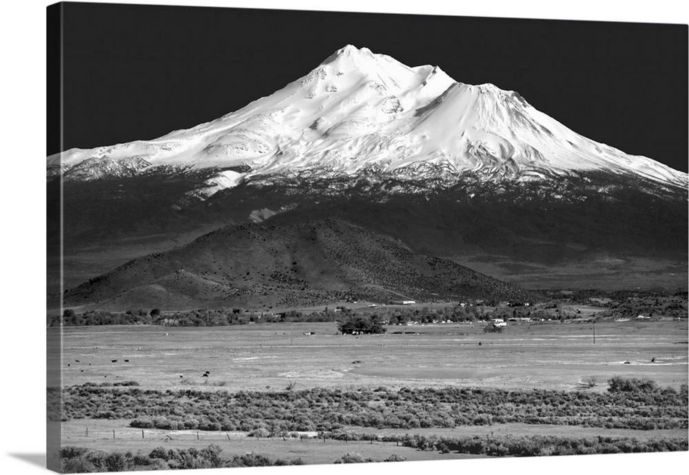 Black and white landscape photograph of Shasta County with a snowy mountain peak in the distance.