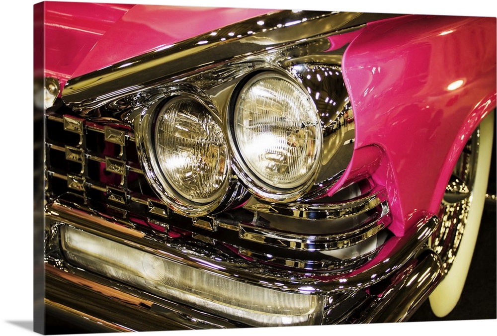 Fine art photograph of the headlights of a hot pink vintage car.
