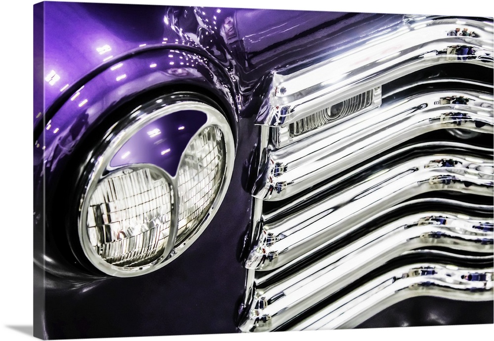 Headlight and grill detail of a bright purple vintage truck.